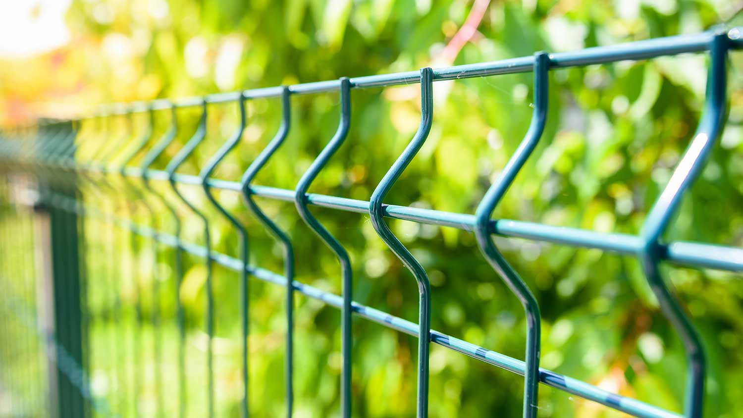 Closeup of a green vinyl coated wire fence