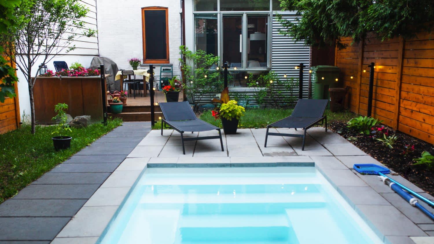 A backyard with a small swimming pool