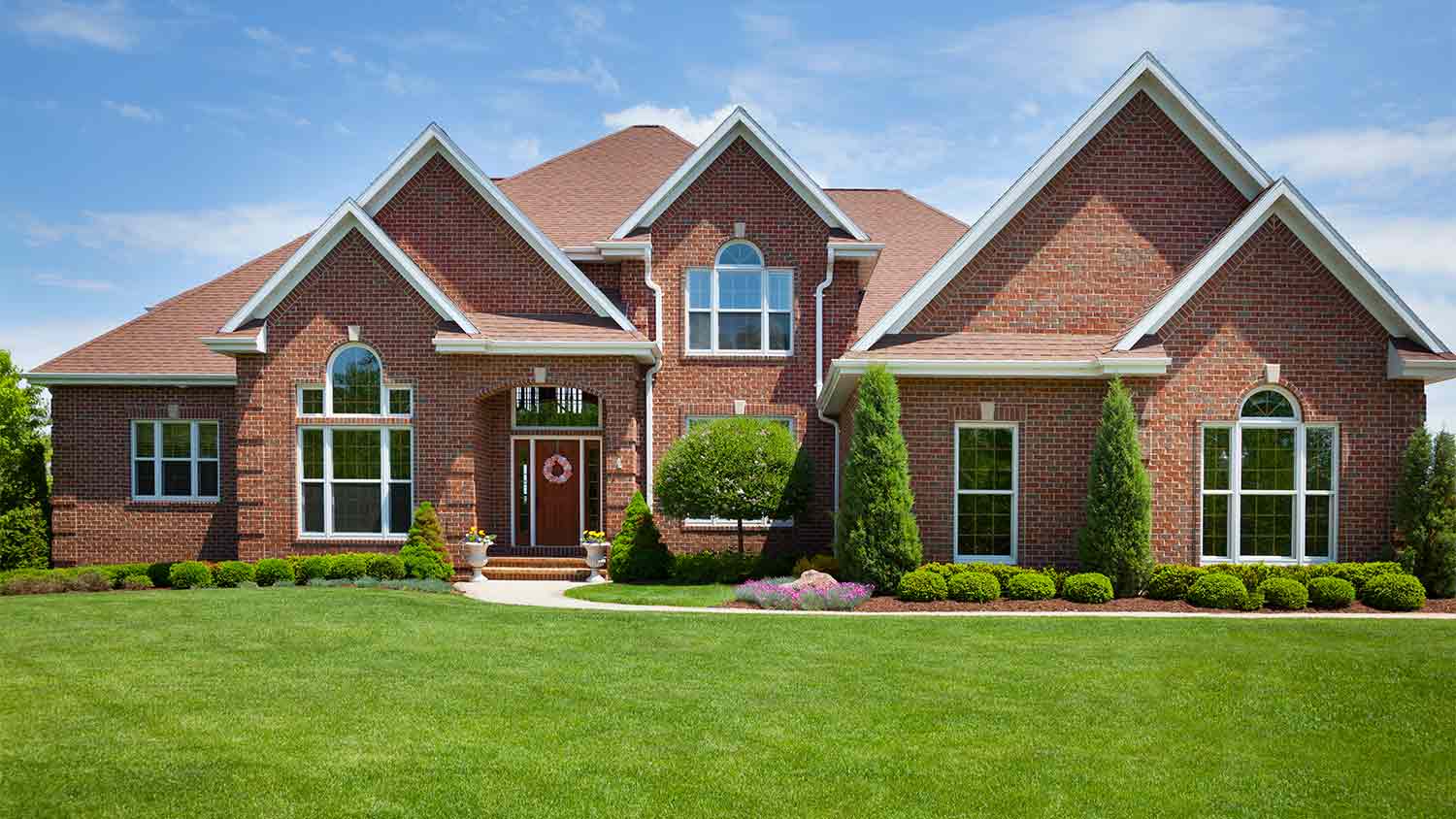 large home with perfect green lawn