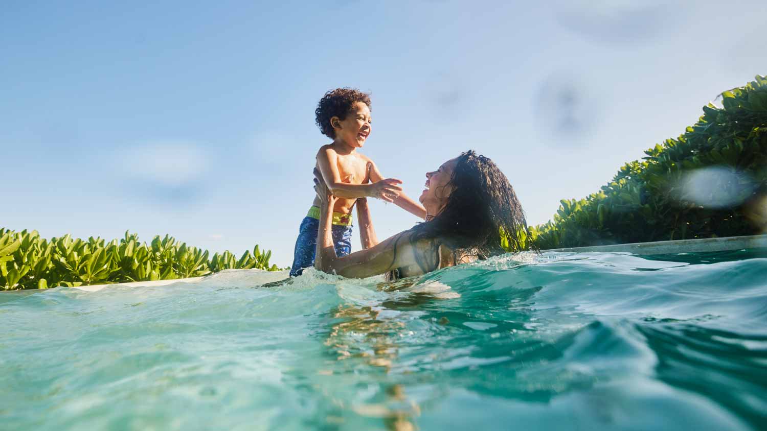 Mother and son playing in pool