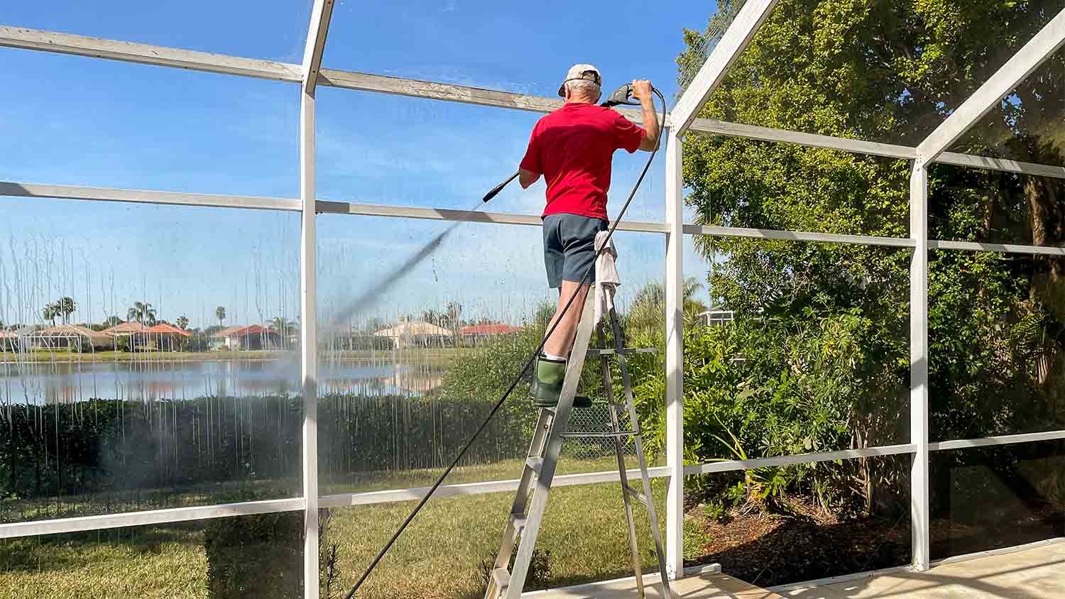 cleaning pool enclosure with power washer