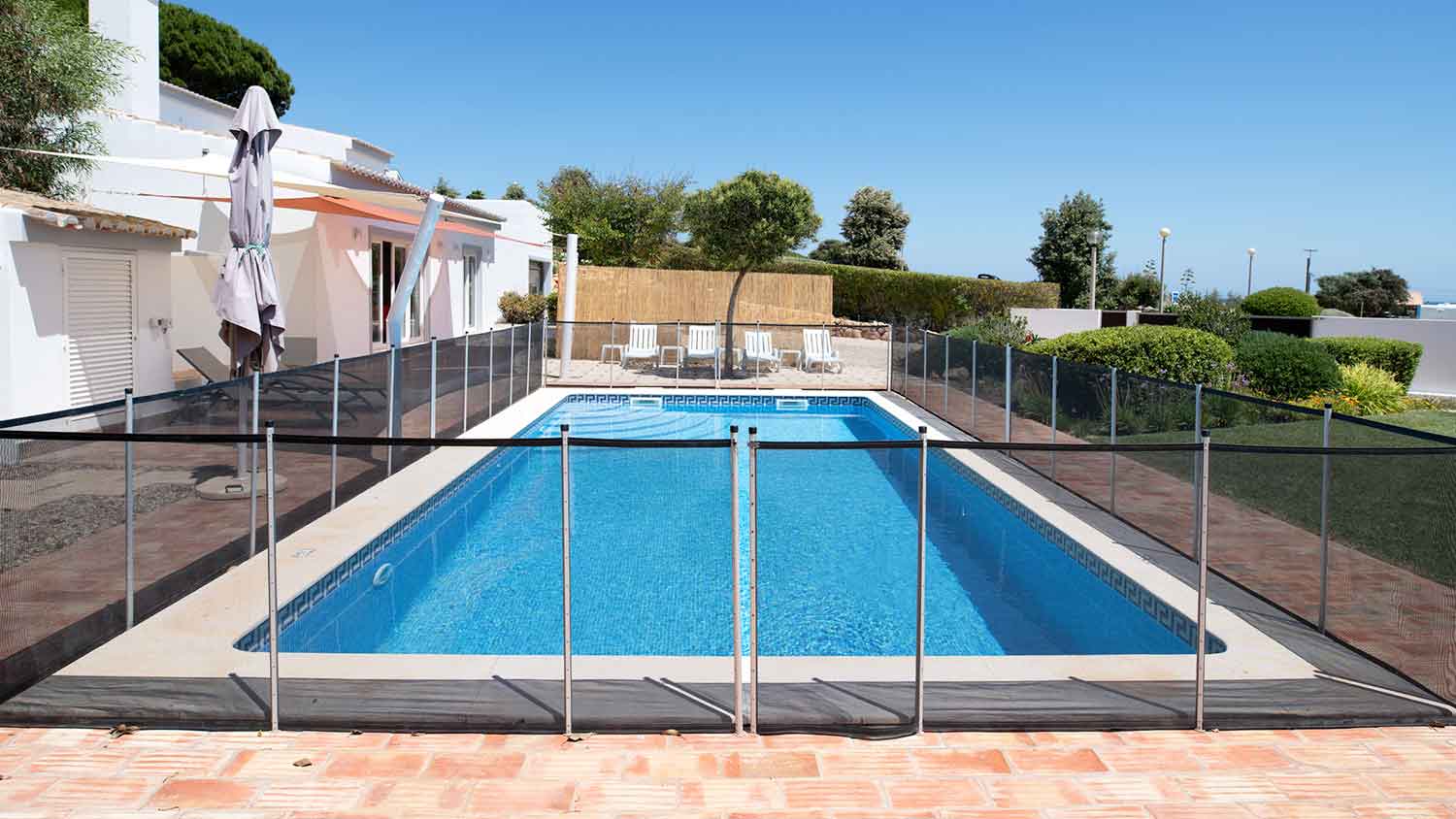 Fenced swimming pool in the backyard