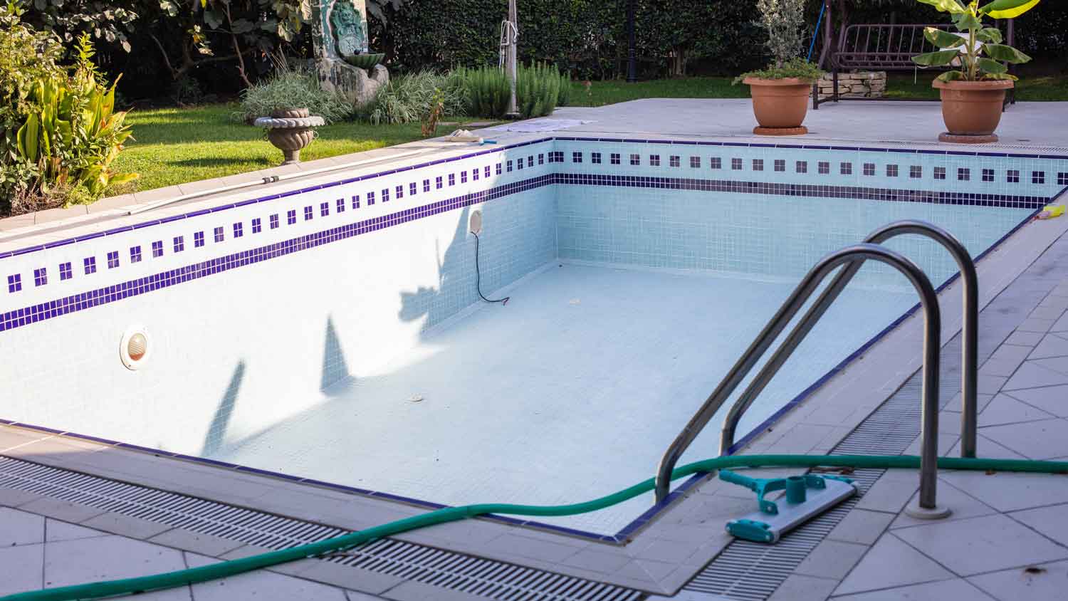 A drained swimming pool in the backyard