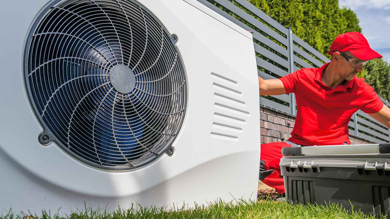 HVAC worker installing swimming pool heat pump