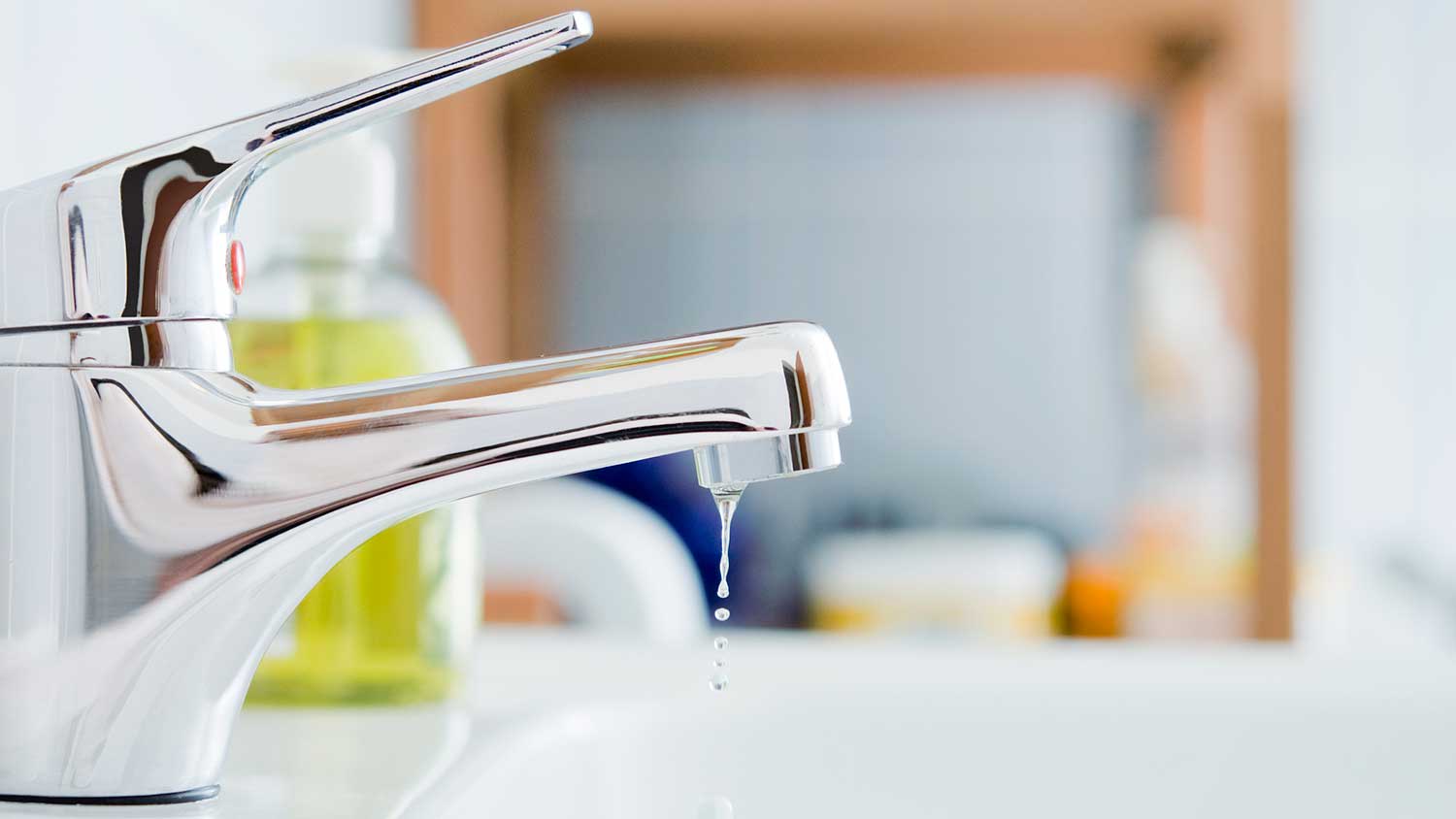 Closeup of a dripping metal bathroom faucet