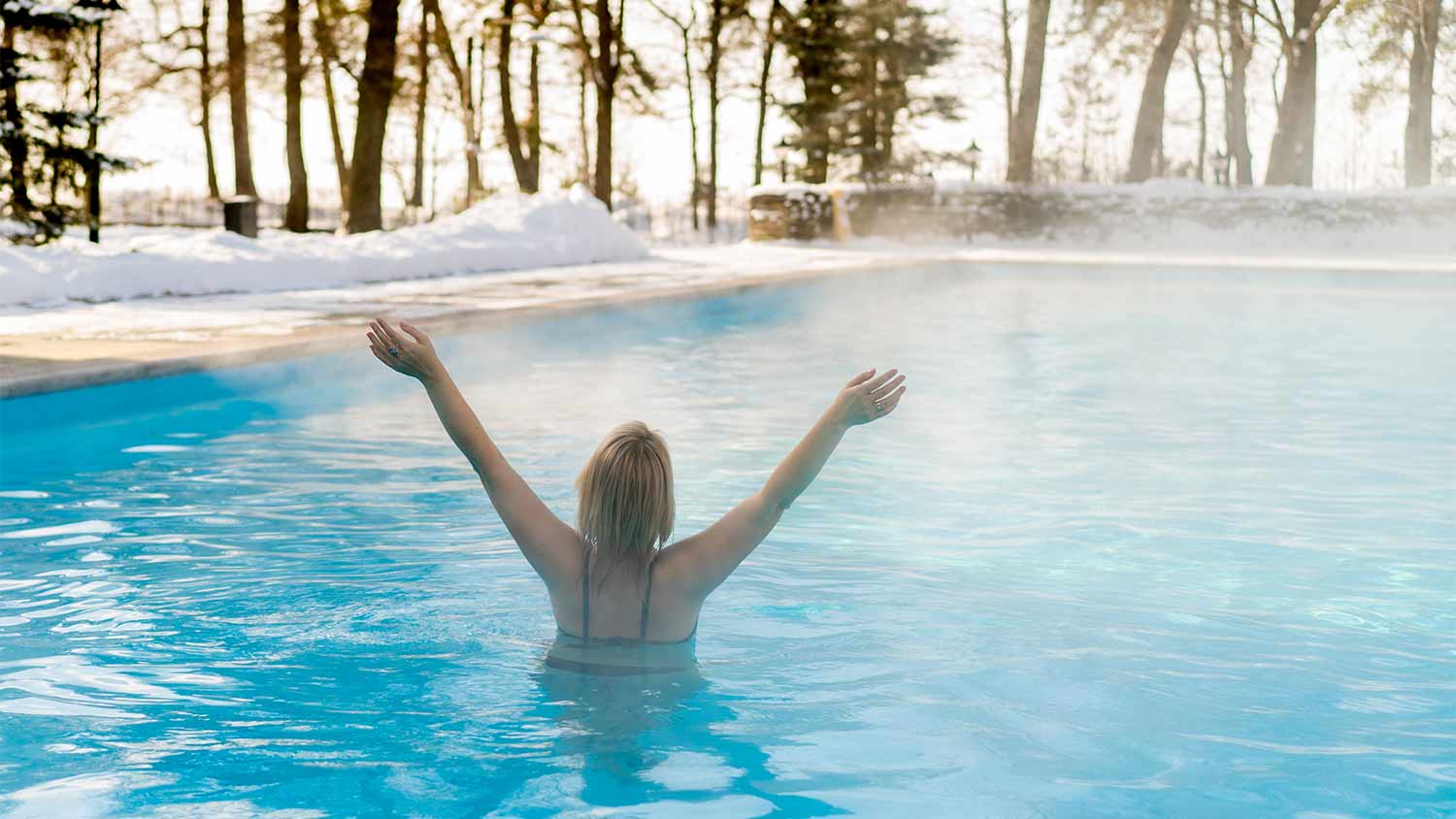 woman in outdoor heated swimming pool