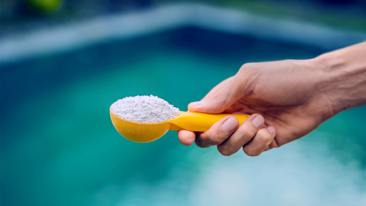 man holding cup of baking soda for pool