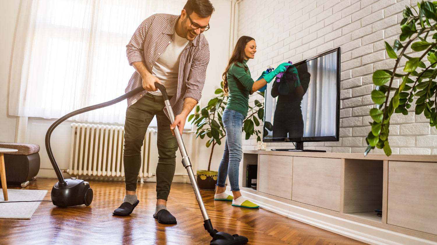 couple cleaning up their apartment before company comes over
