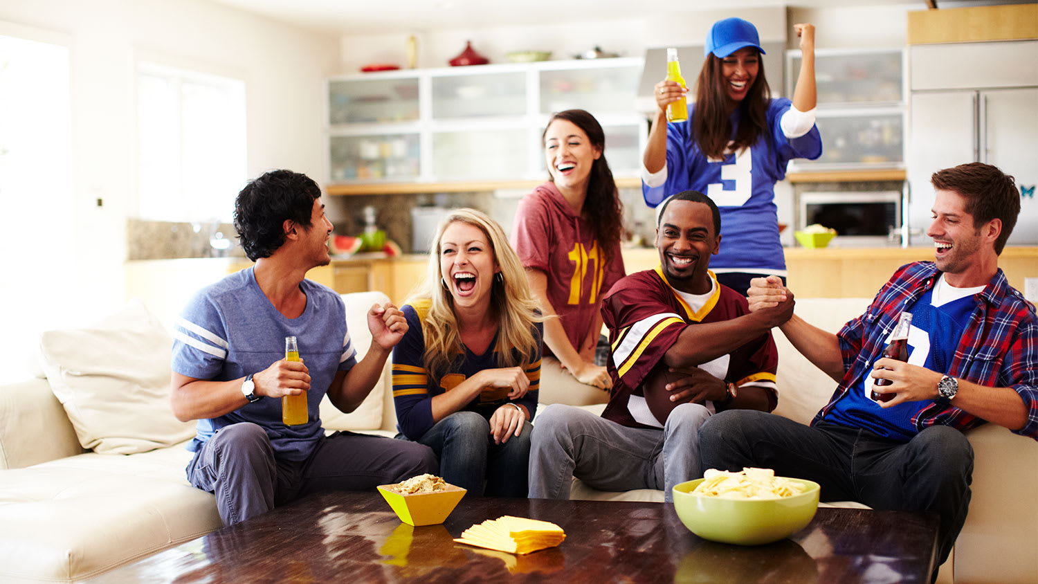 friends watching game in living room