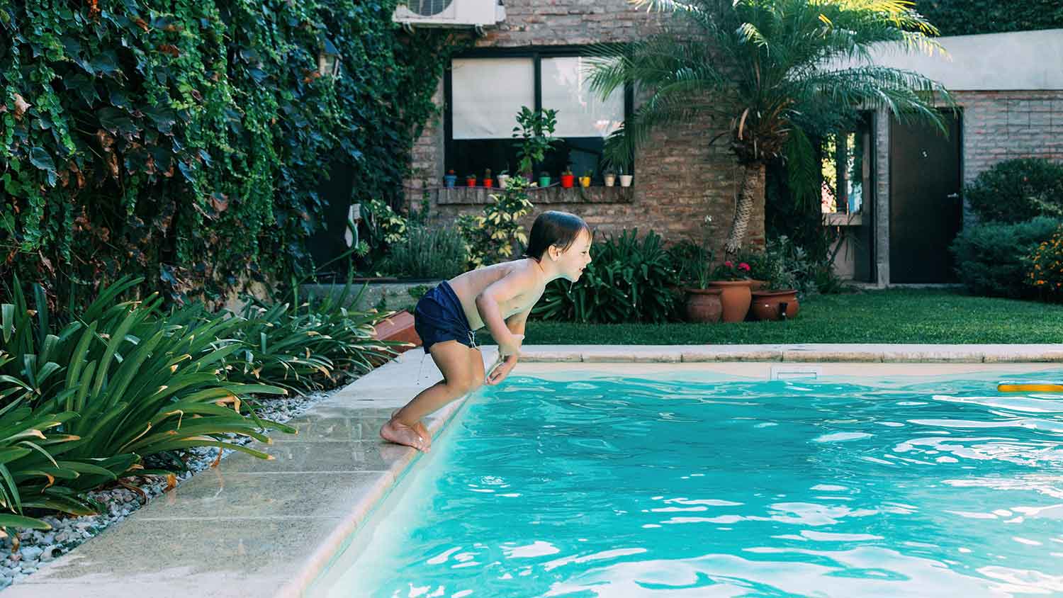 Little boy jumping in the swimming pool