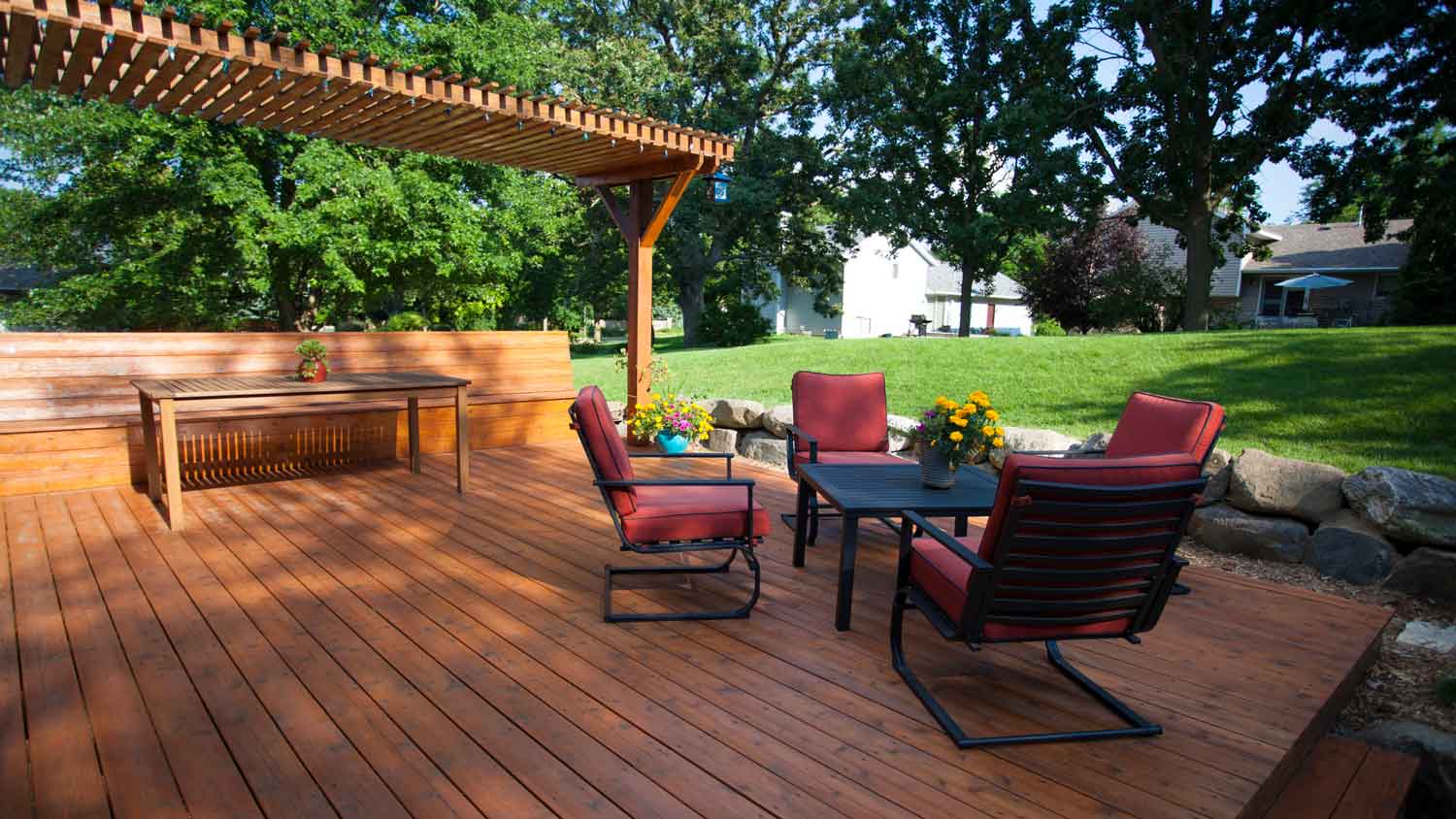 A deck and a pergola in a beautiful garden