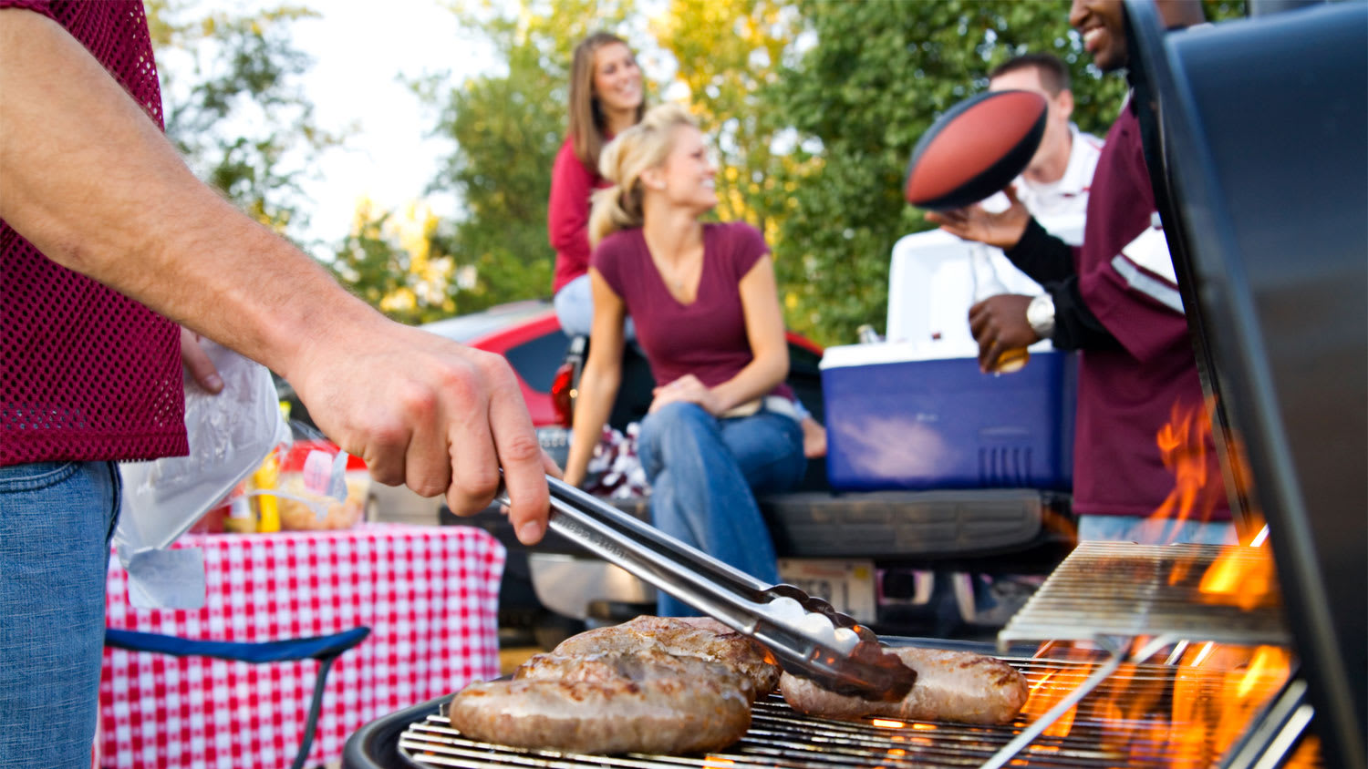 man grilling at a tailgating party