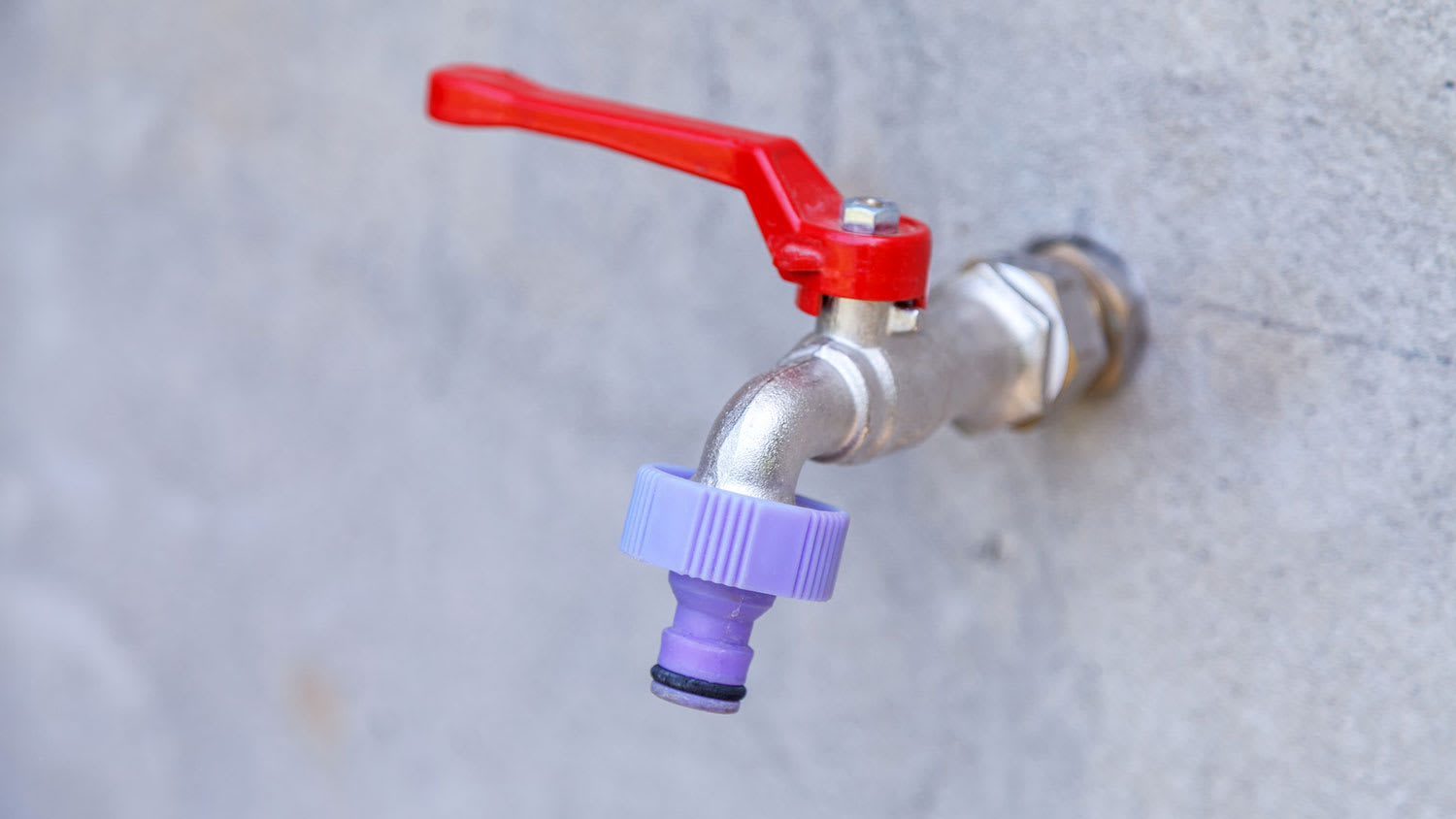 Outdoor water spigot mounted on the wall