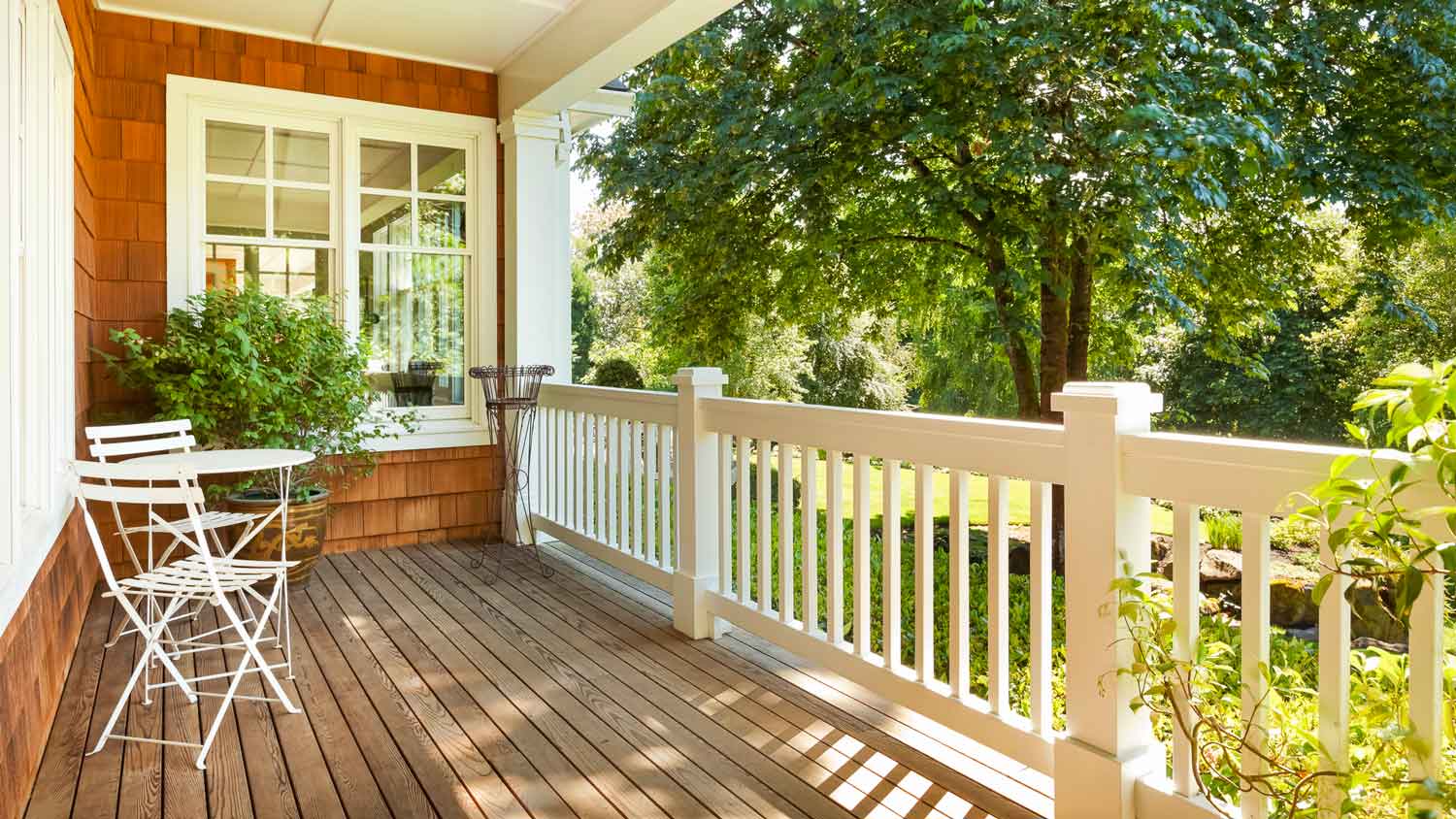 A beautiful wooden deck with white railings