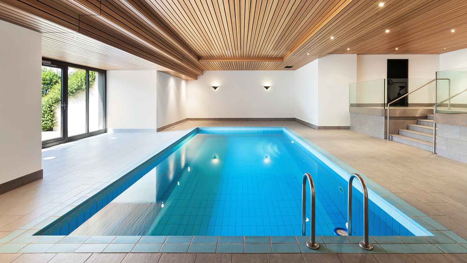 Luxury indoor pool with wooden ceiling