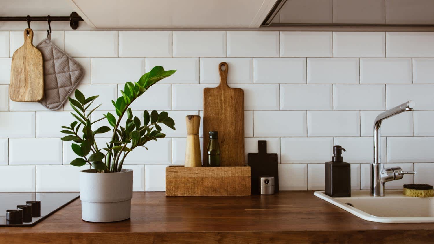 Kitchen with white tiles wall and wood table