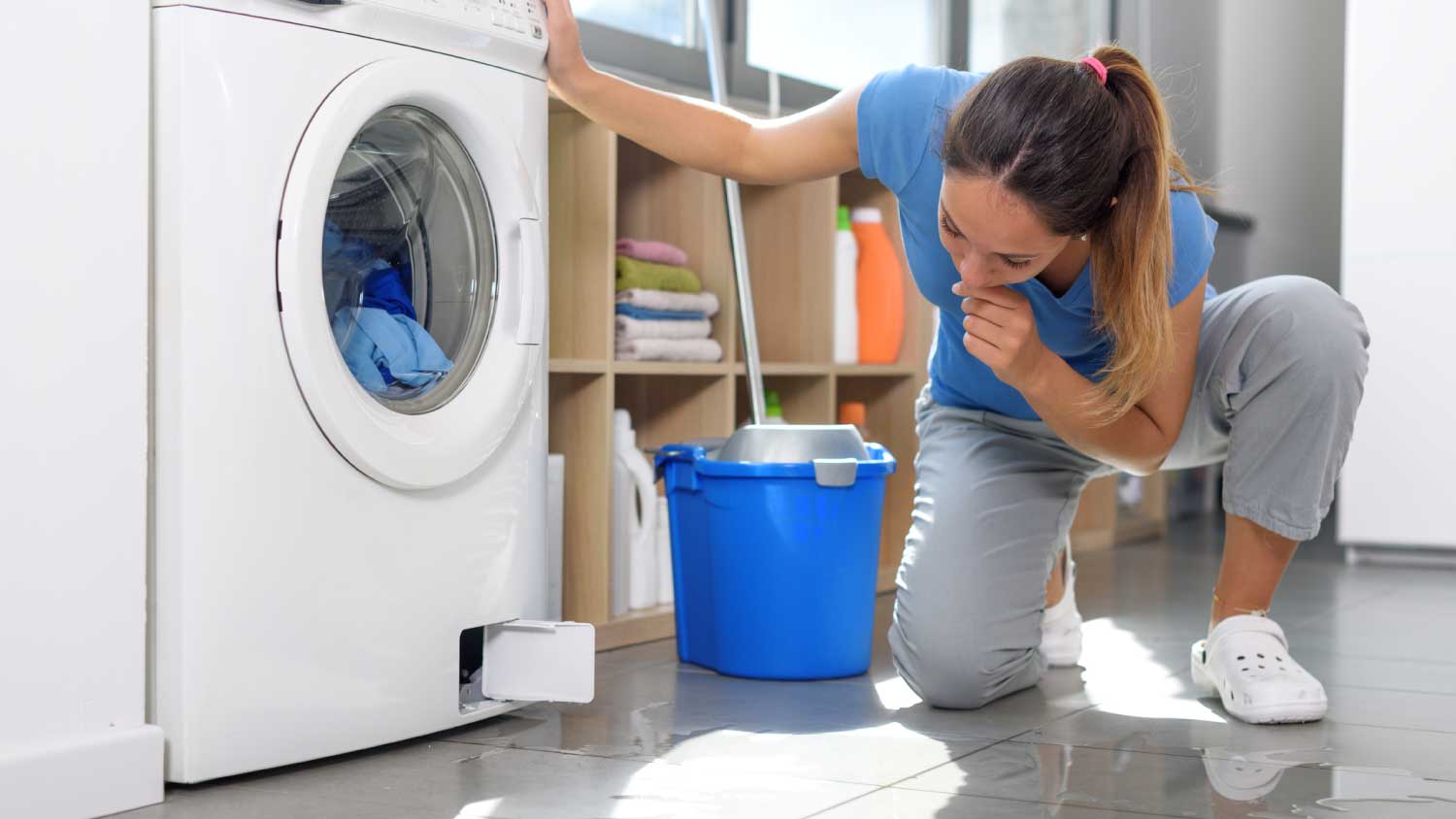 Woman checking a water leak on the floor