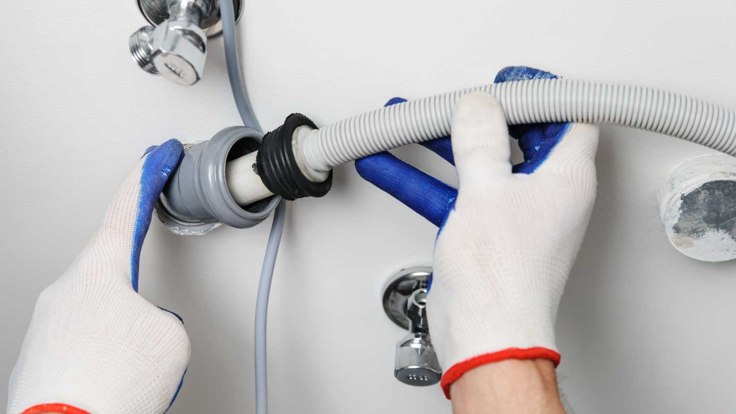 Worker attaching a drain hose