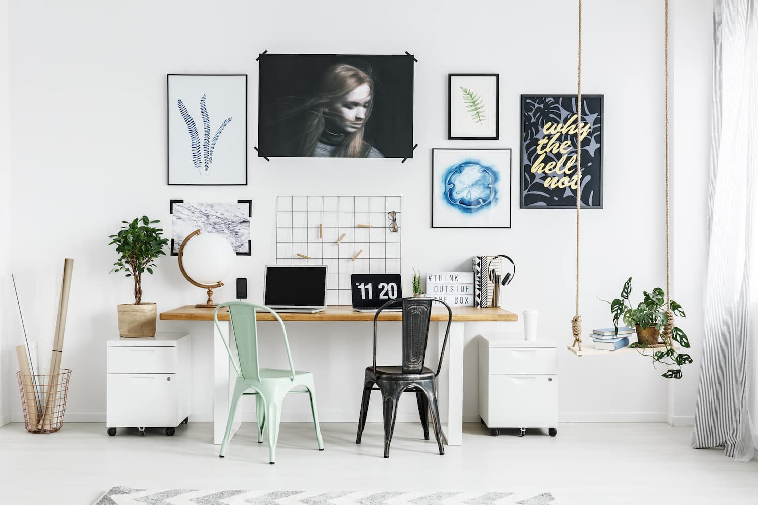 Modern home office with wooden desk and bold art hung above the desk