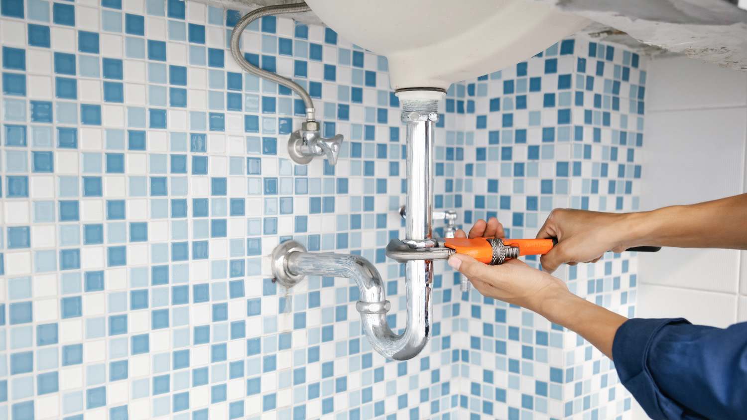 Plumber fixing pipes