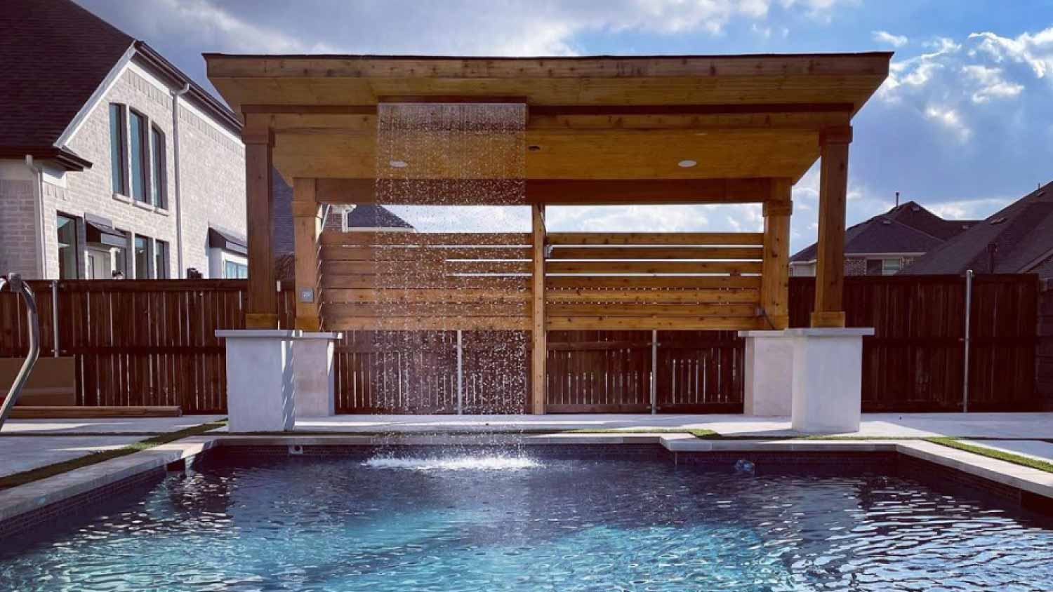 A view of a pergola with a waterfall