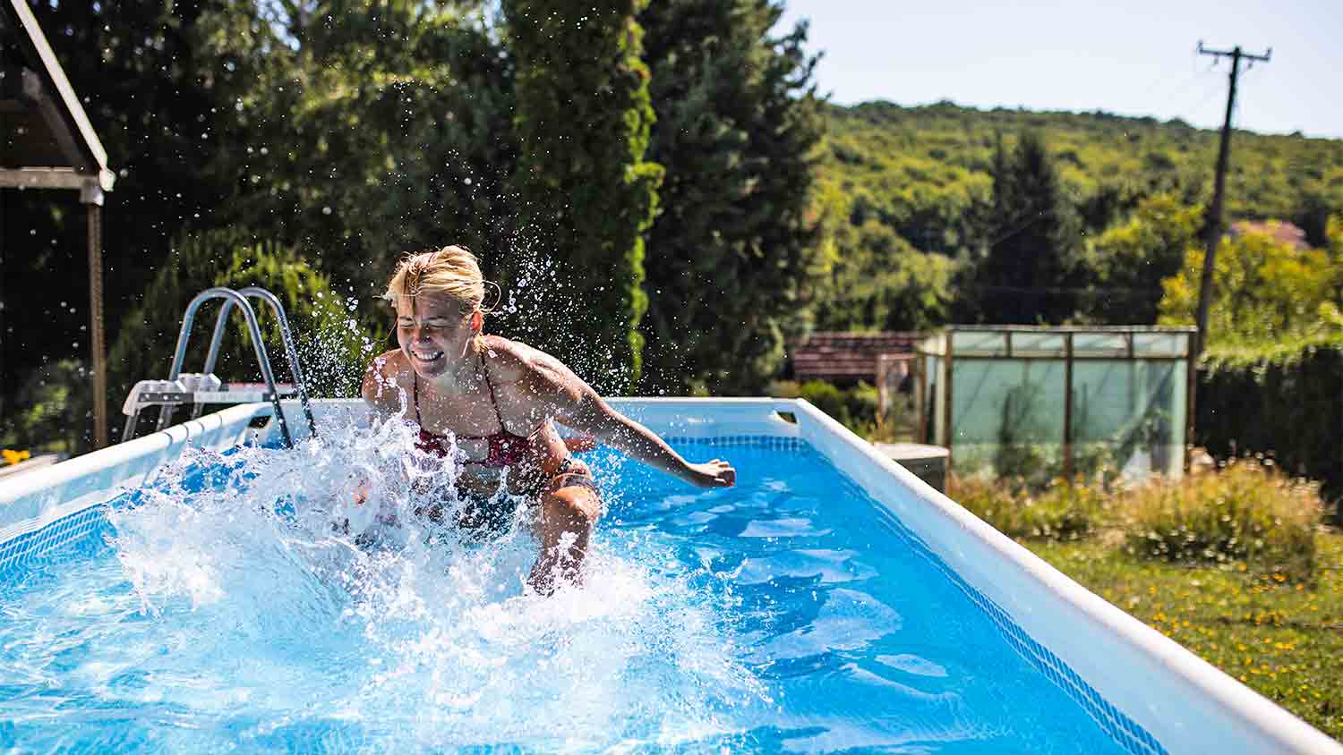 woman diving into an above-ground pool
