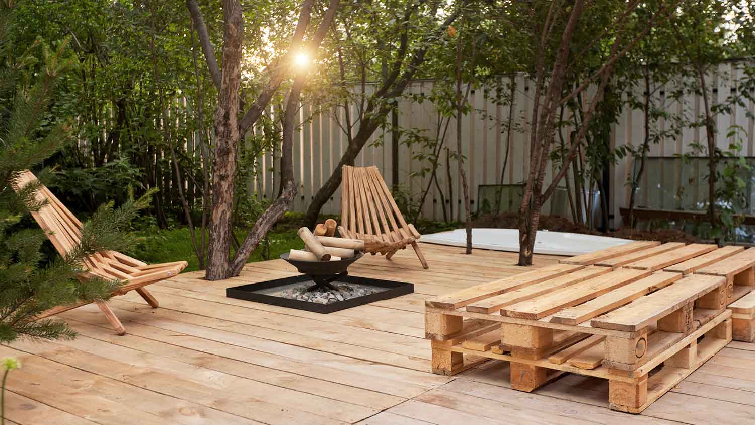 Patio deck with wooden chairs and a tree