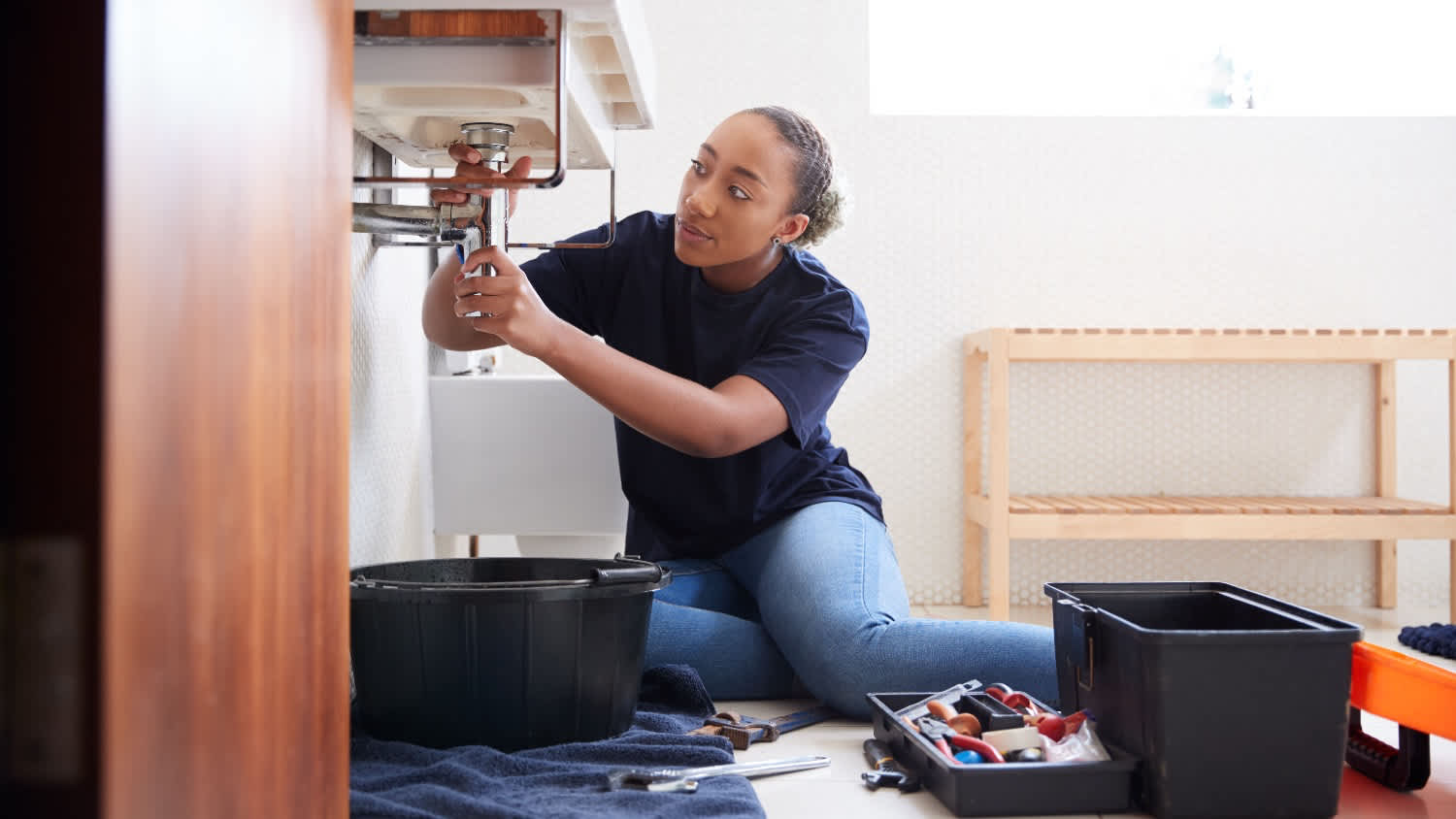plumber fixing leaky bathroom sink