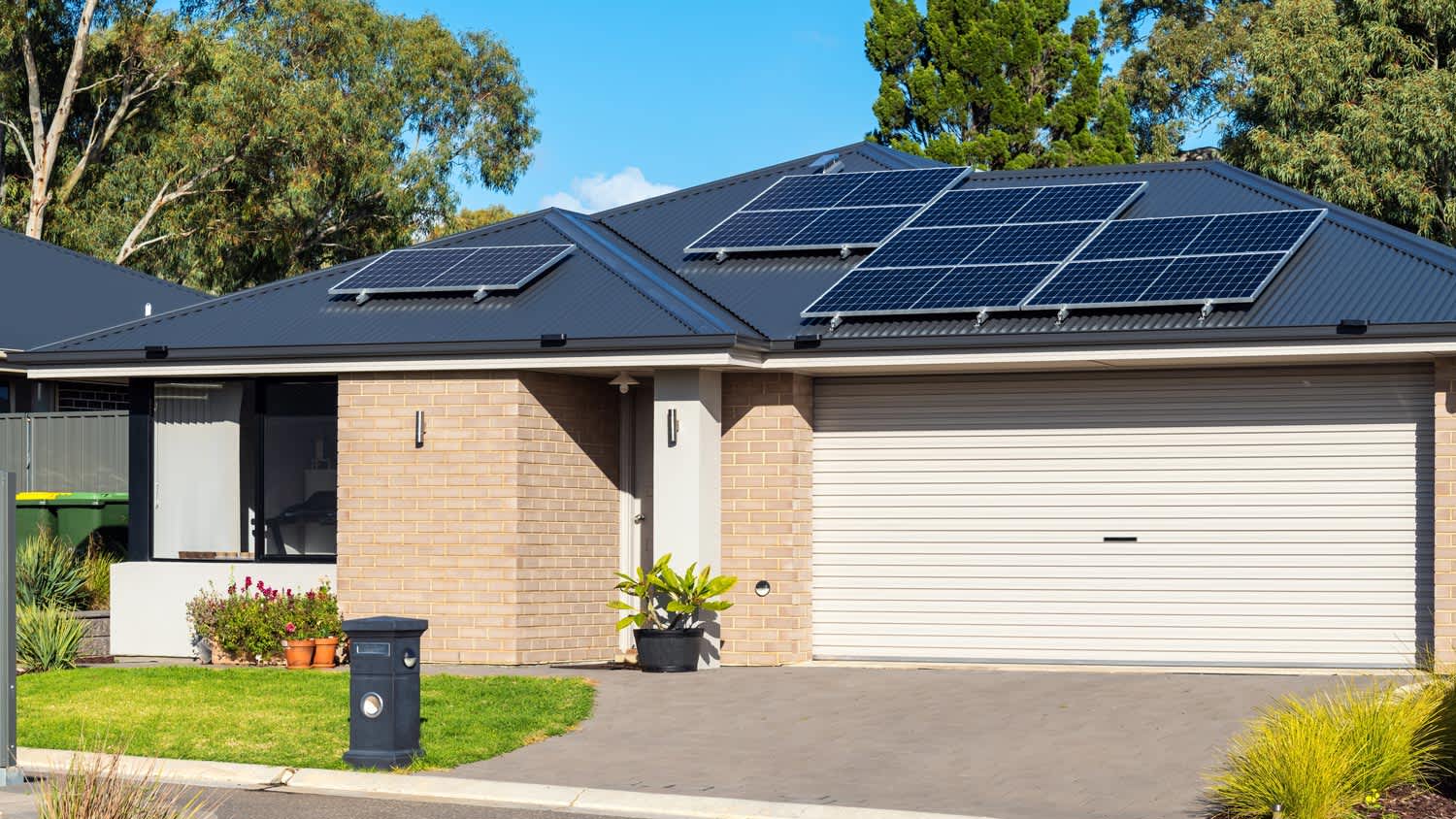 The exterior of a house with solar panels on the roof and a garage