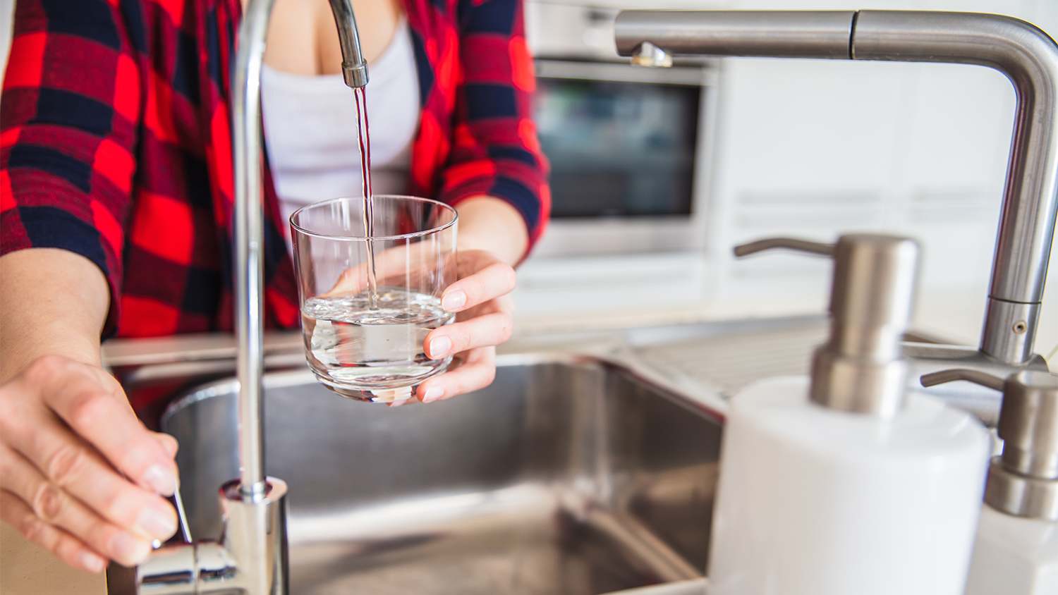 Woman pouring water into a cup