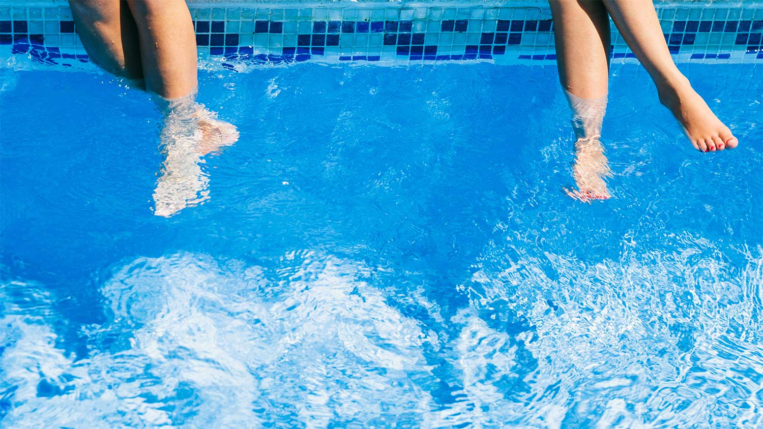 Feet dangling in pool