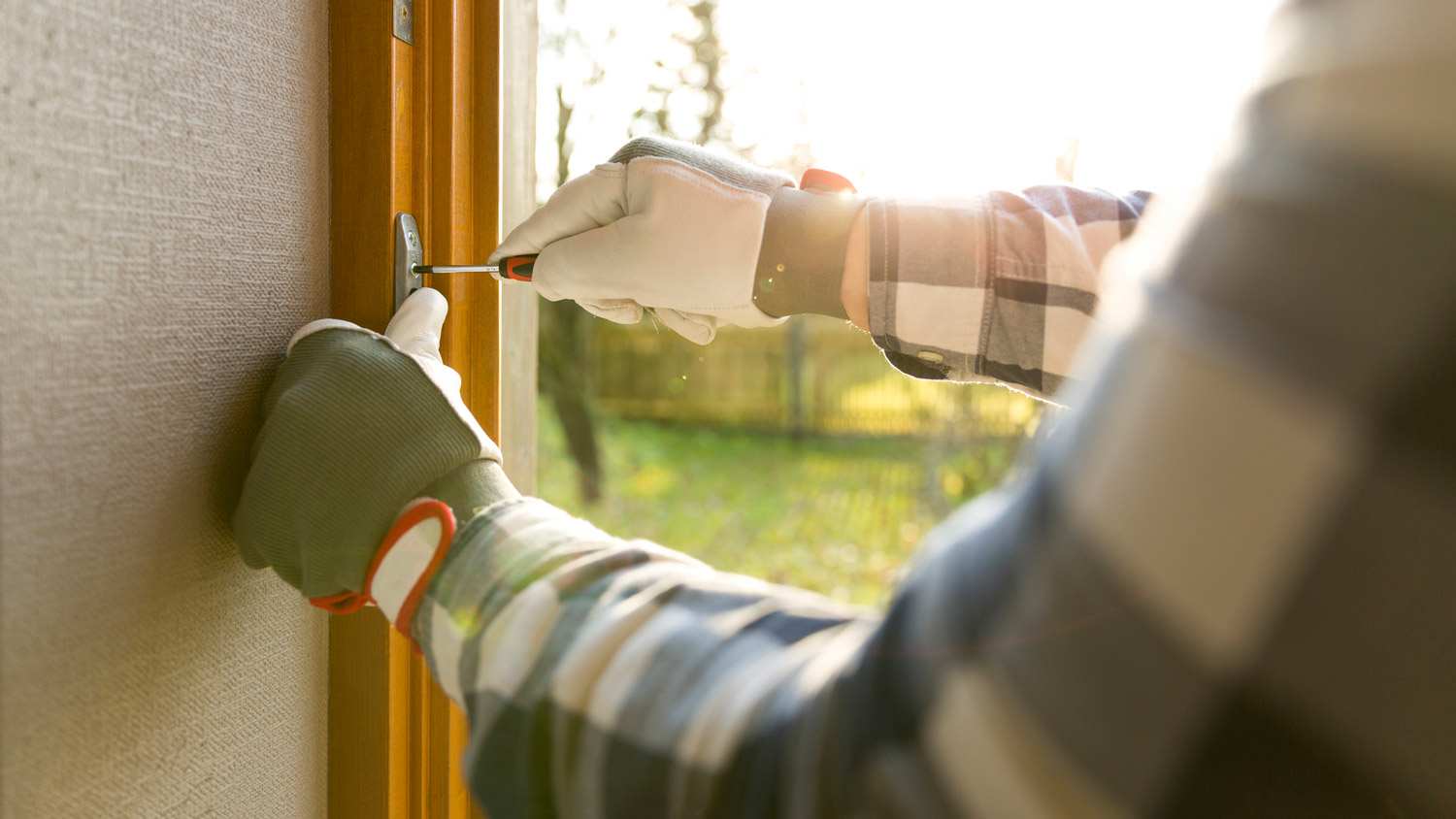 A handyman installing a new window
