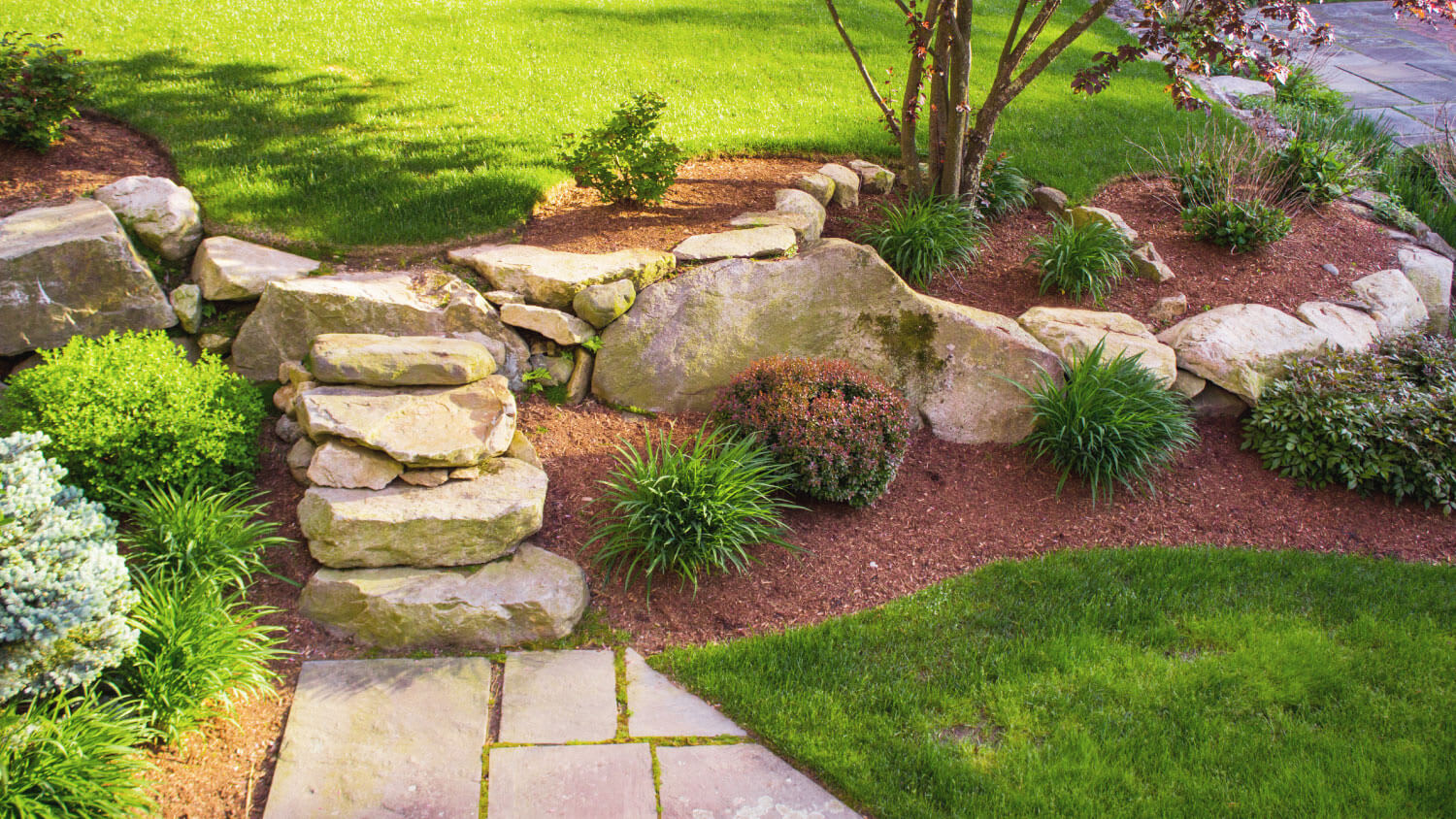 shrub landscaping by boulder stairs
