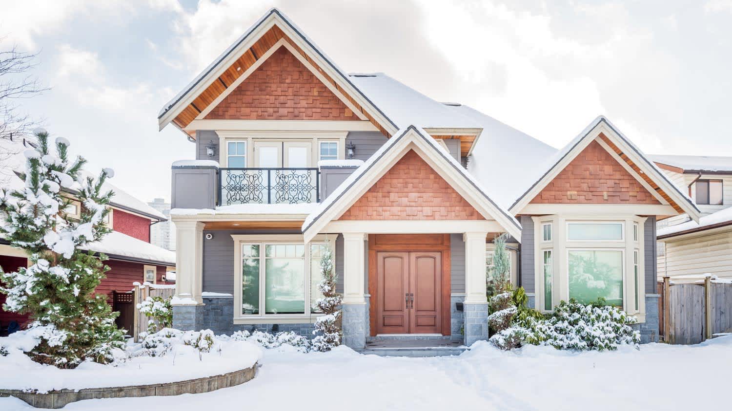 A suburban house covered in snow