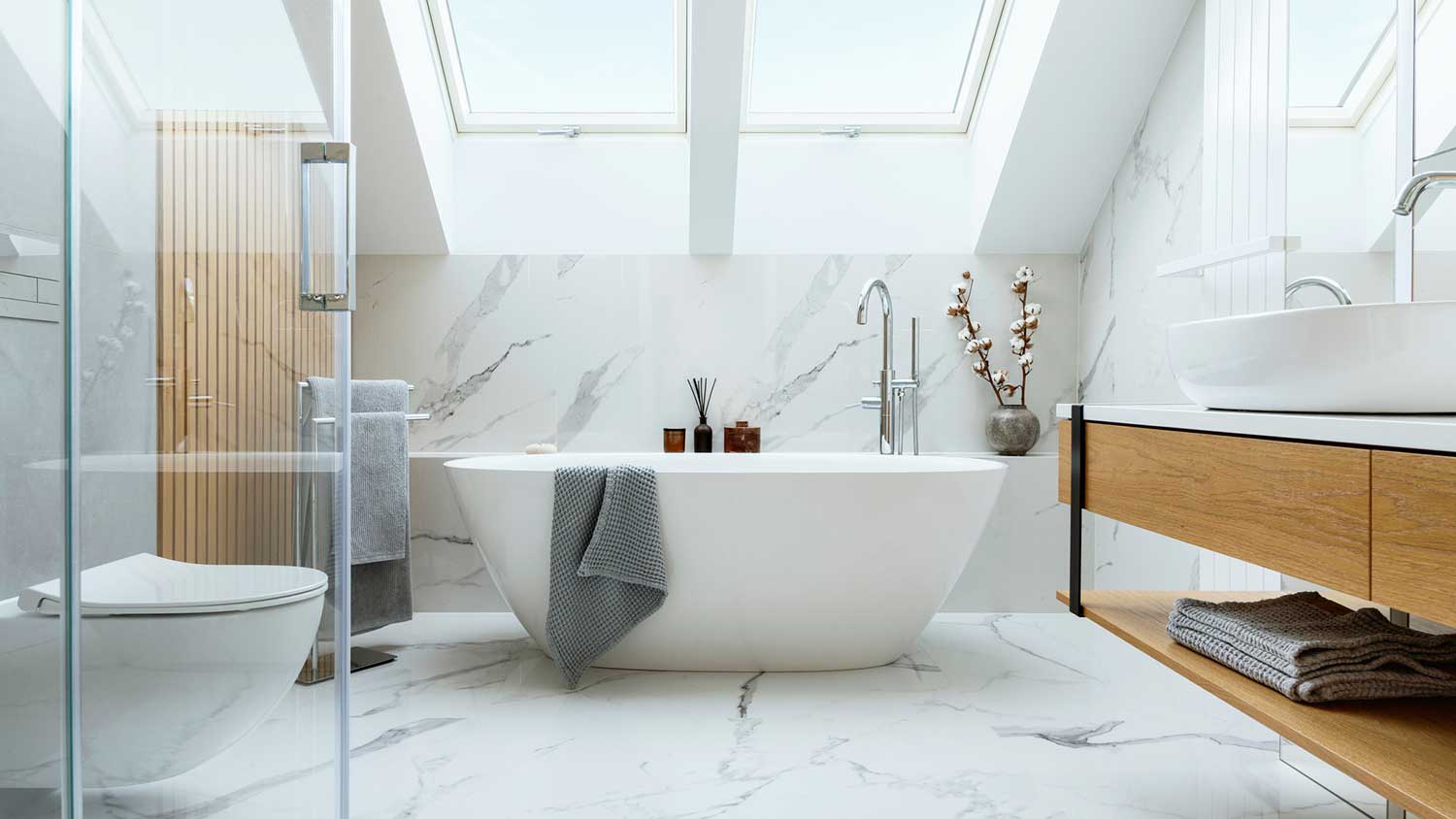 Bright bathroom with marble panels and bathtub