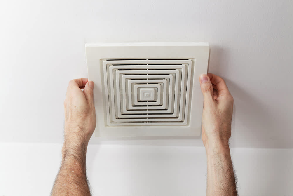 Person installing a fan cover