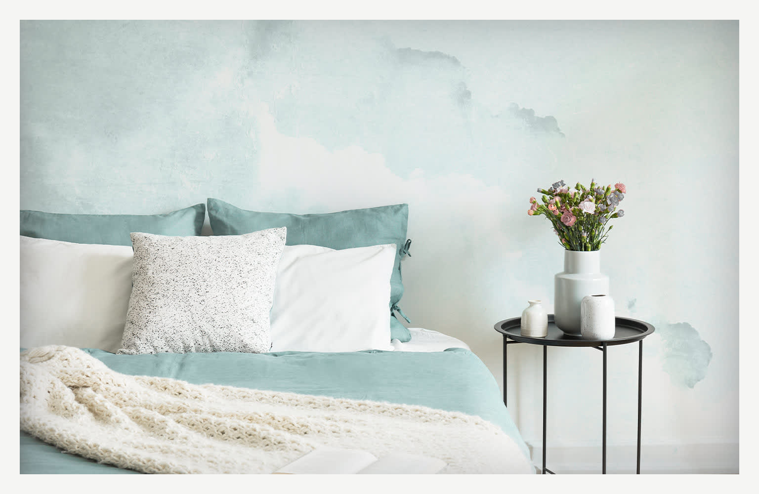 teal watercolor wall painting above bed and side table