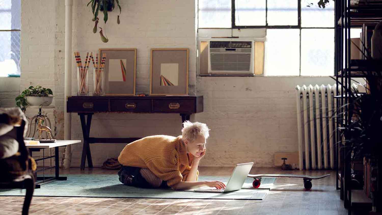 woman sitting on the floor using her laptop