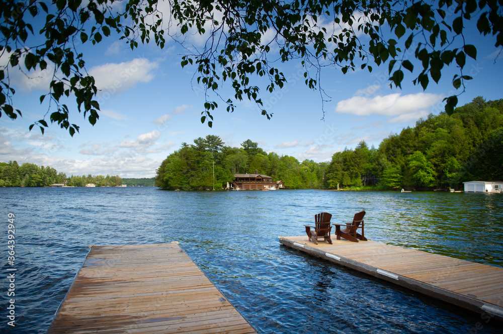 Adirondack chairs on a wooden dock