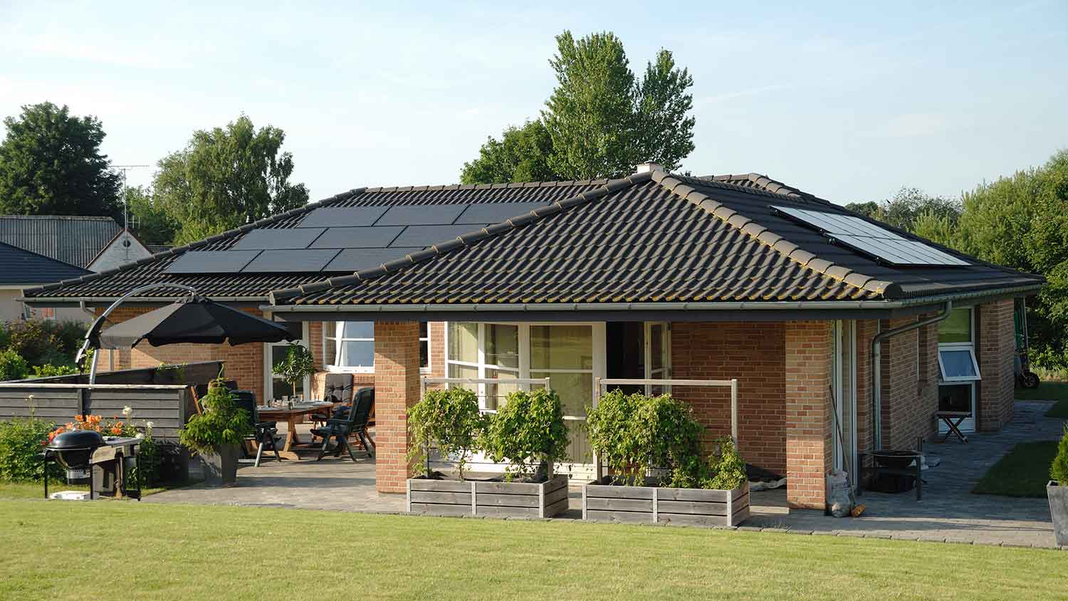 Suburban brick house with solar panels on the roof