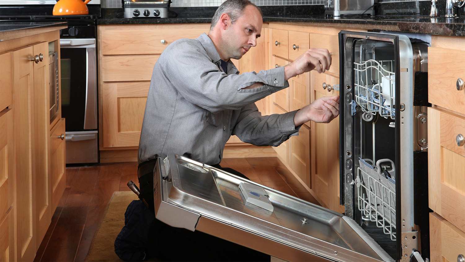Man repairing a dishwasher