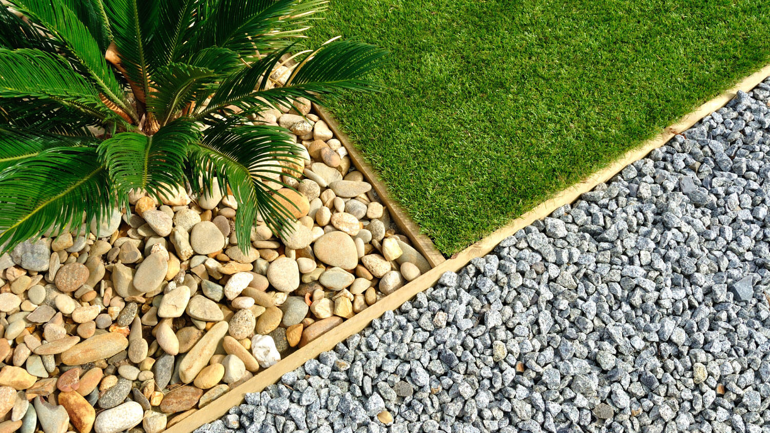 divided pebbles and grass landscaping
