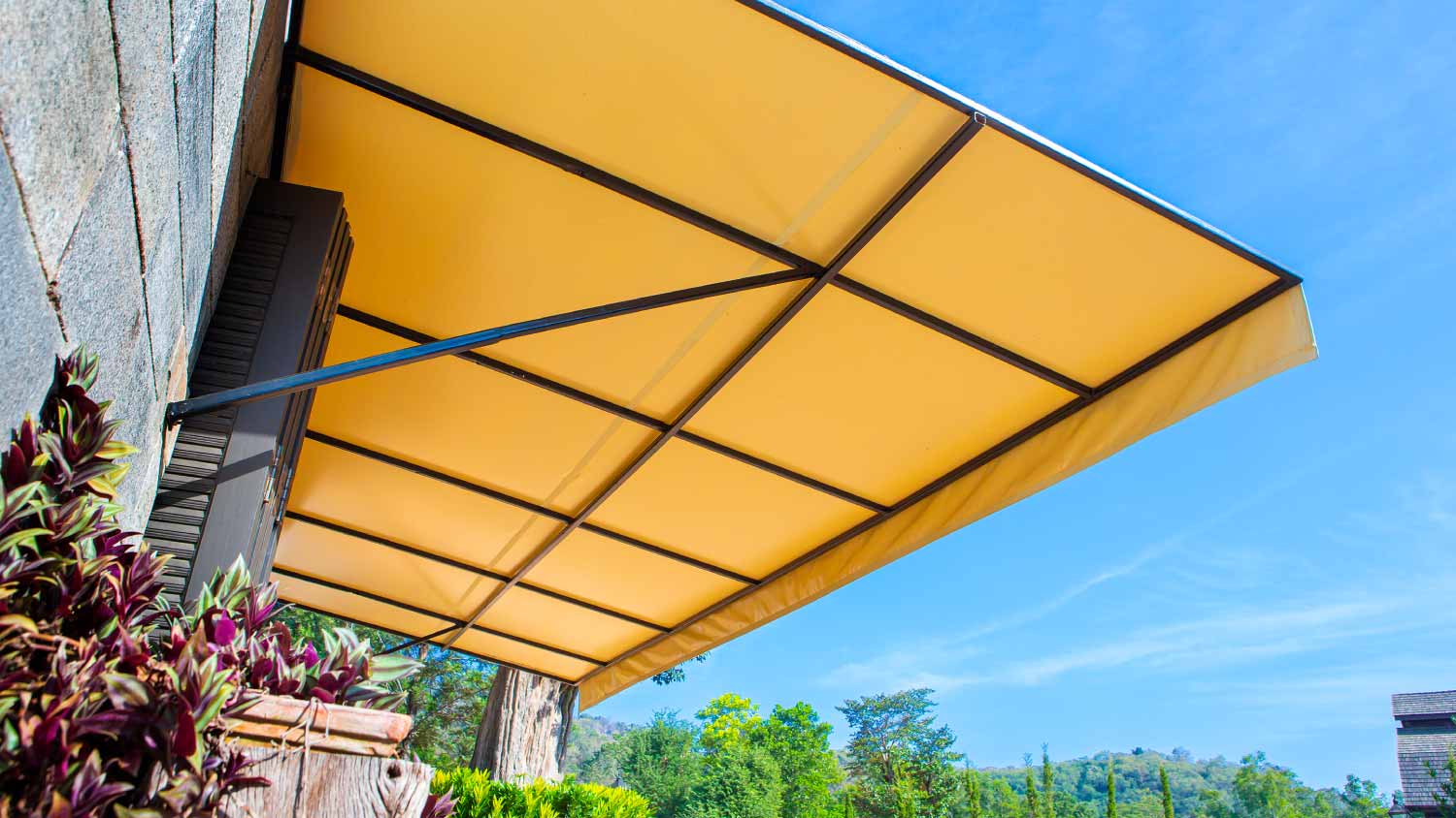 Sun protection canvas in front of a house