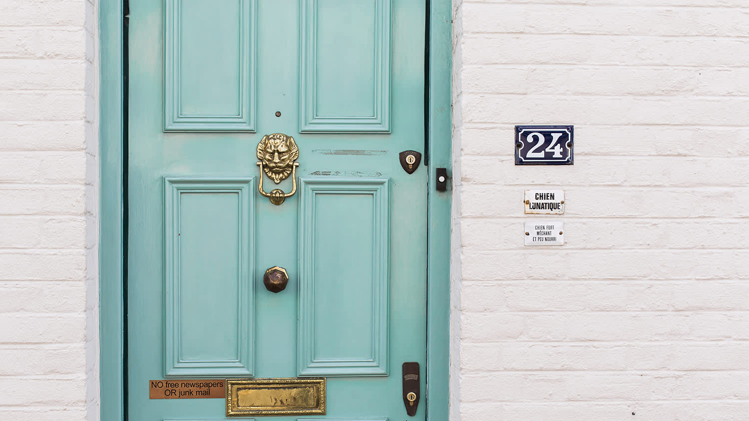 light blue door, white brick house