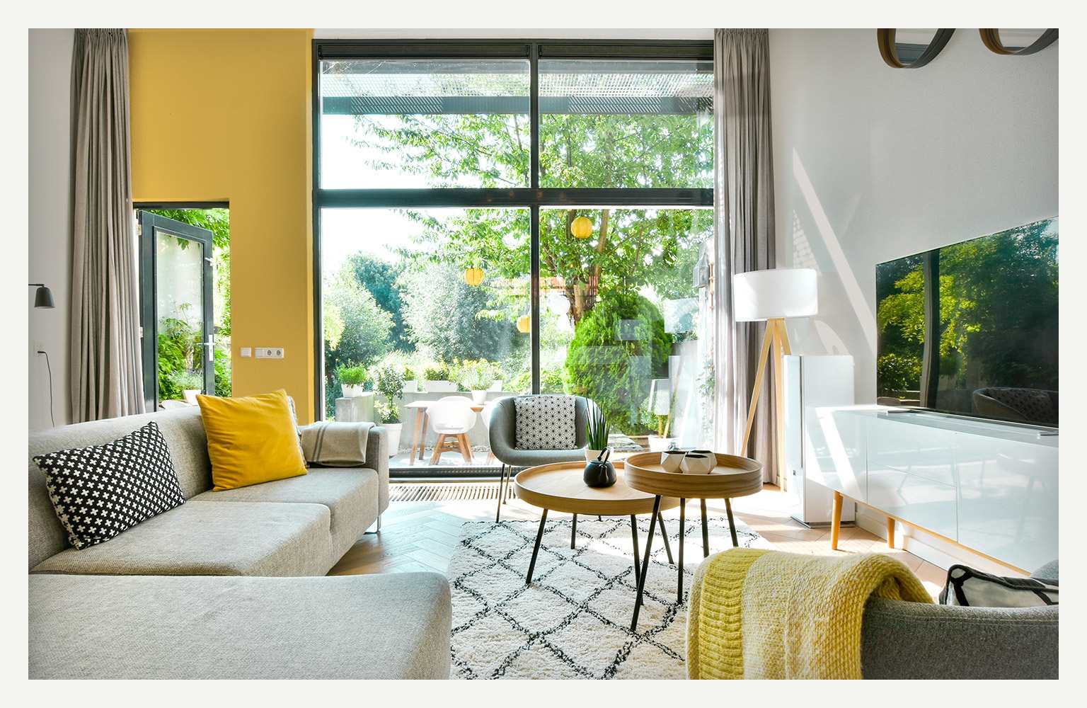 living room with couch and TV and big open windows