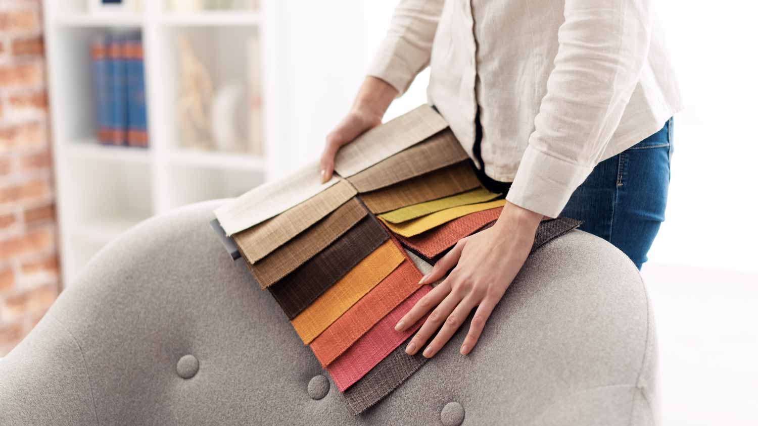 A woman choosing the best upholstery for the armchair