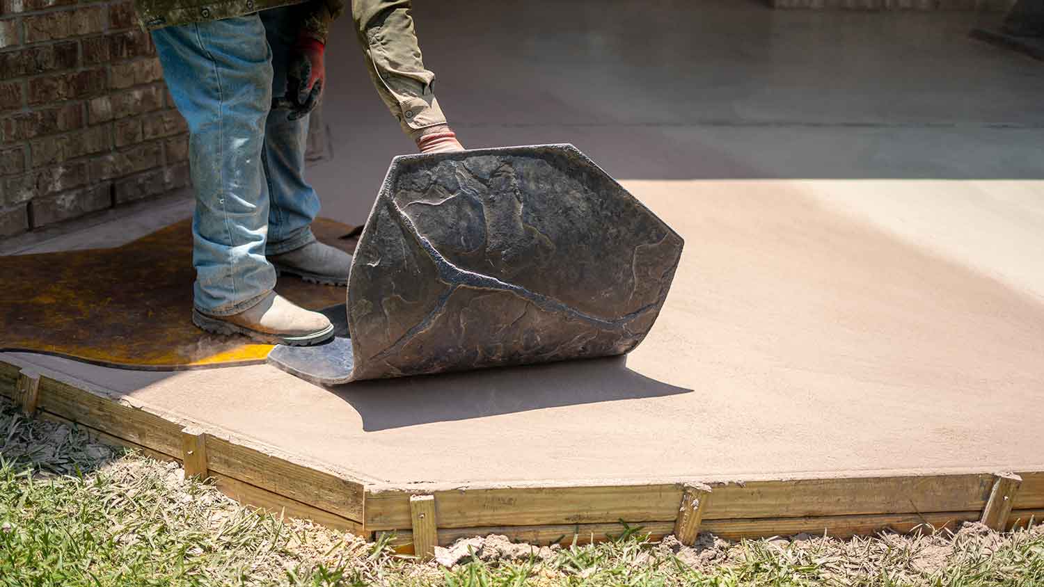 worker stamping concrete