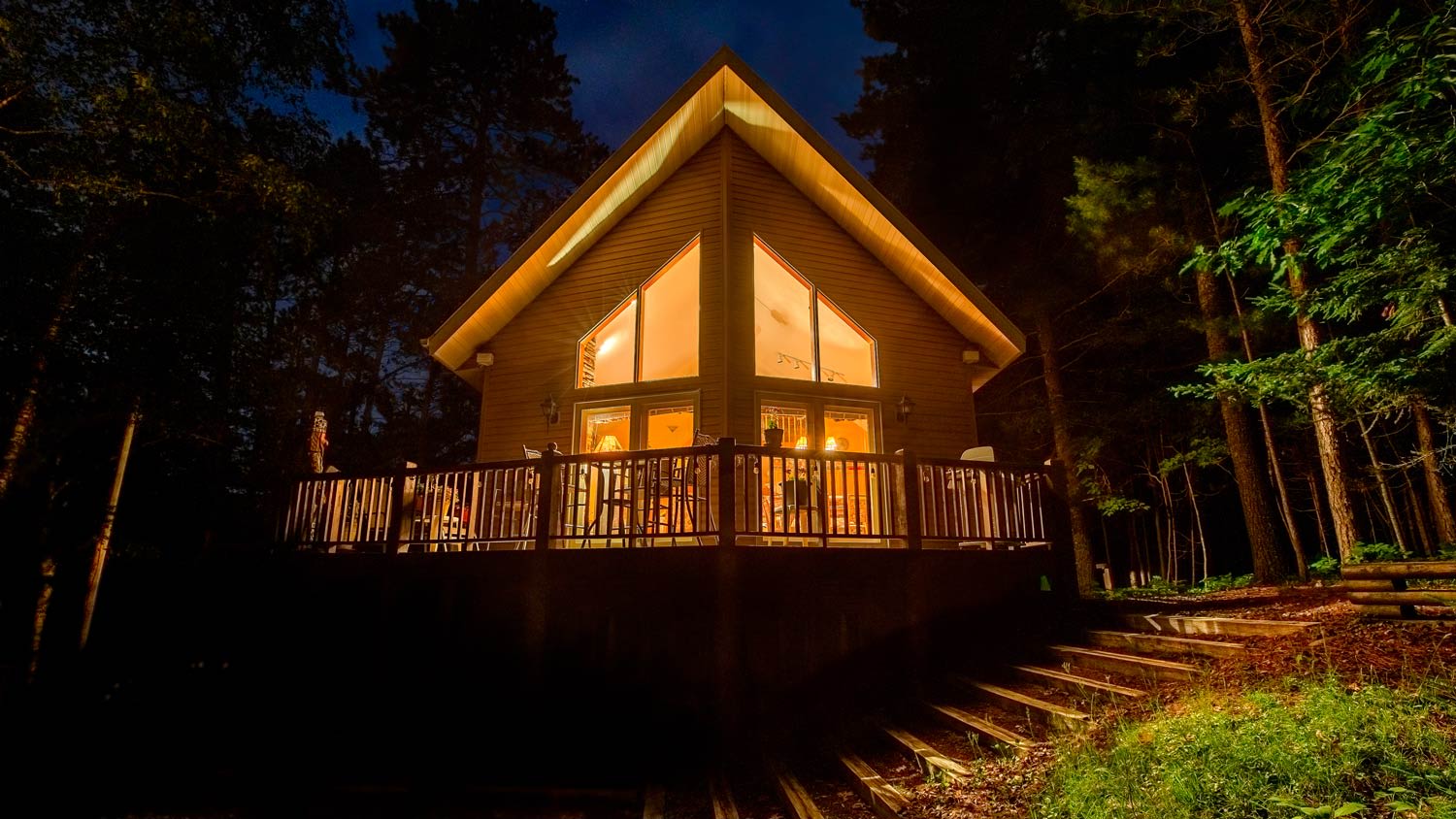 A chalet in the woods at night