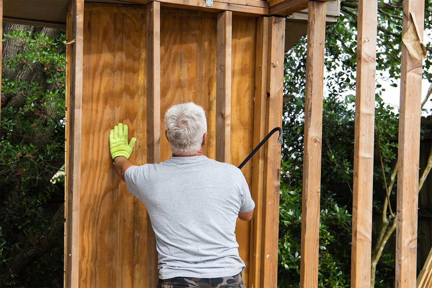 Man taking apart walls of house
