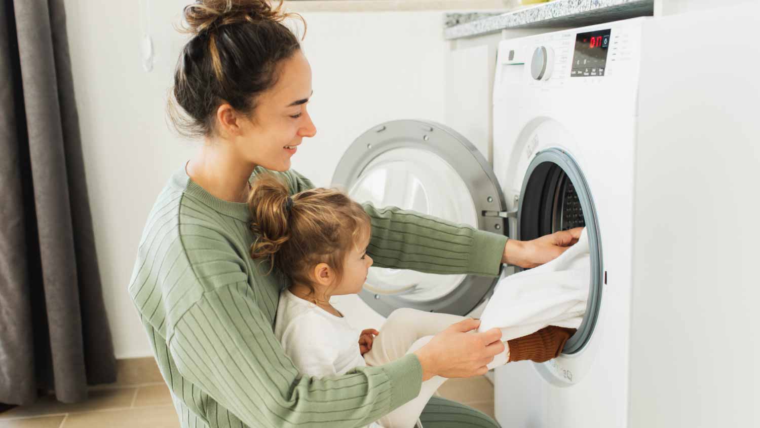 Mother and her daughter doing laundry